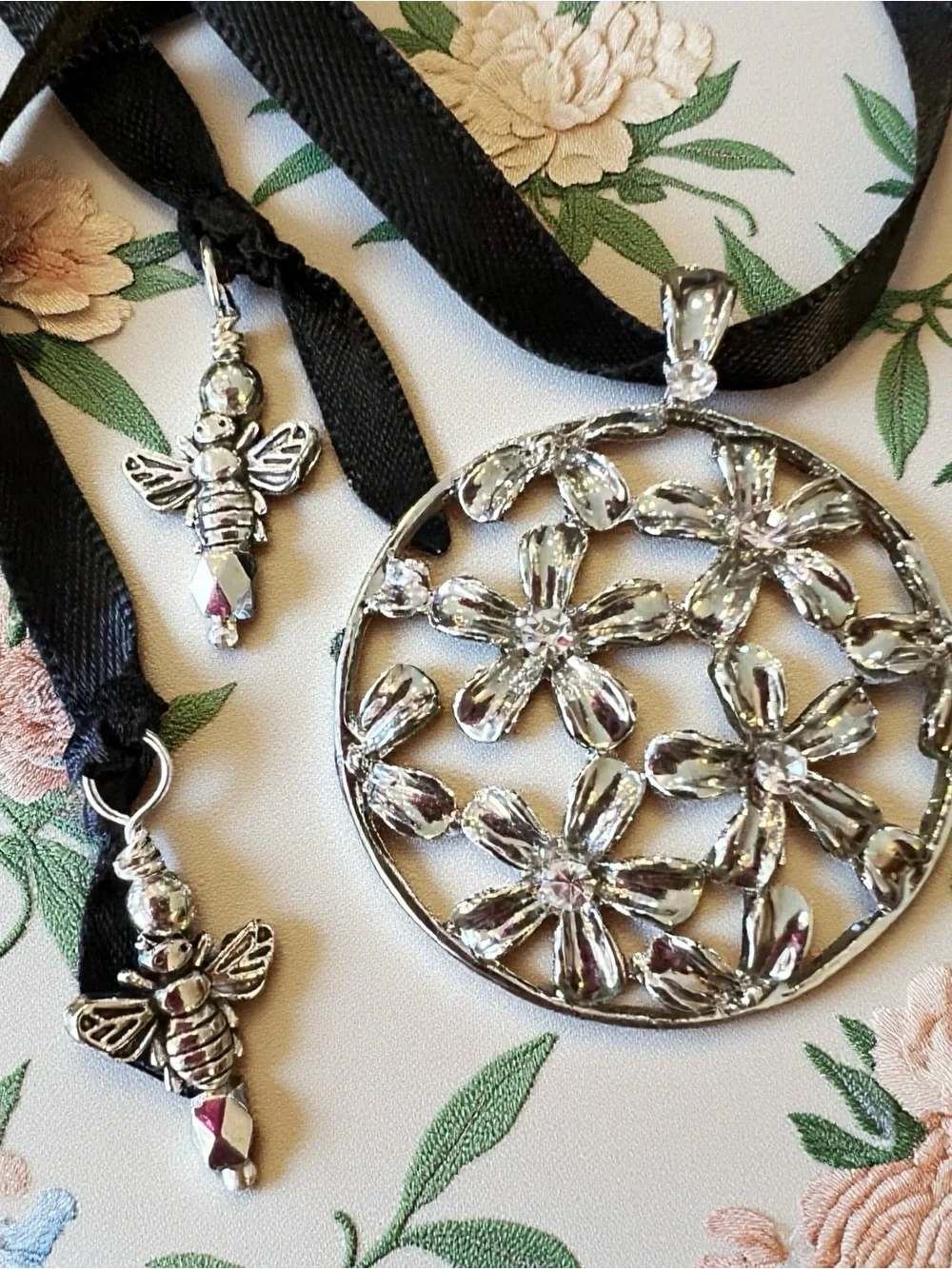 Silver Toned Floral Cutout Pendant Necklace on Black Satin Ribbon